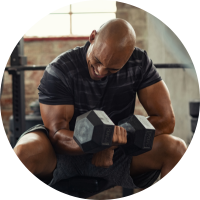 A man lifting weights in a gym, showcasing strength and determination in his fitness routine.