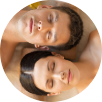 A couple enjoying a serene spa experience together in a beautifully decorated spa room.